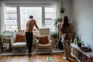 Man and woman cleaning together showing the unequal division of labour