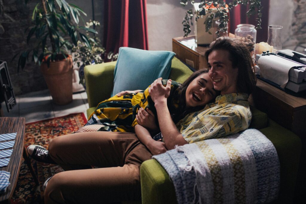 couple cuddling on sofa