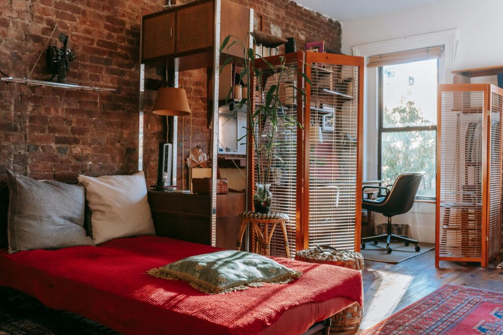 bedroom and office separated by folding screen