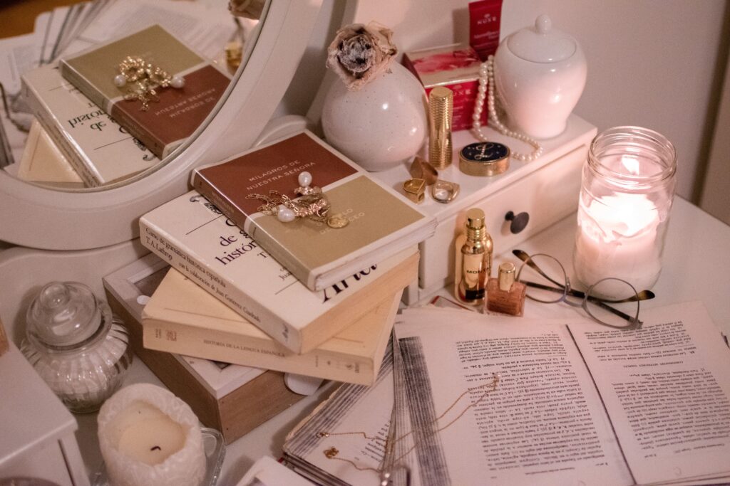 Aesthetic candles and books on dressing table - inspiration for renter-friendly bedroom ideas