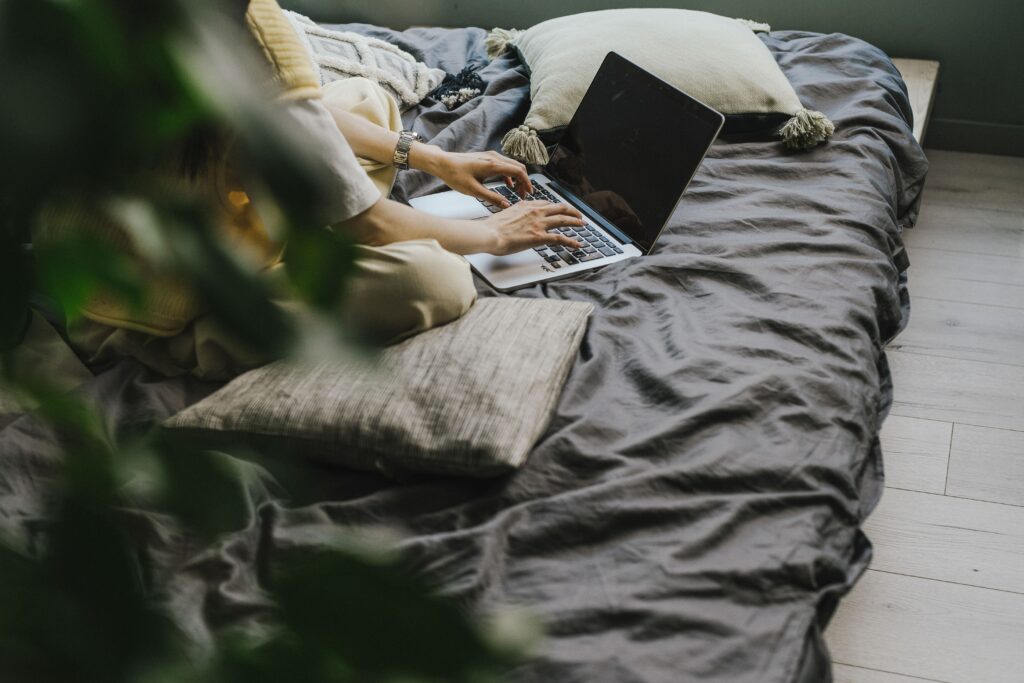 girl working from bedroom in house share